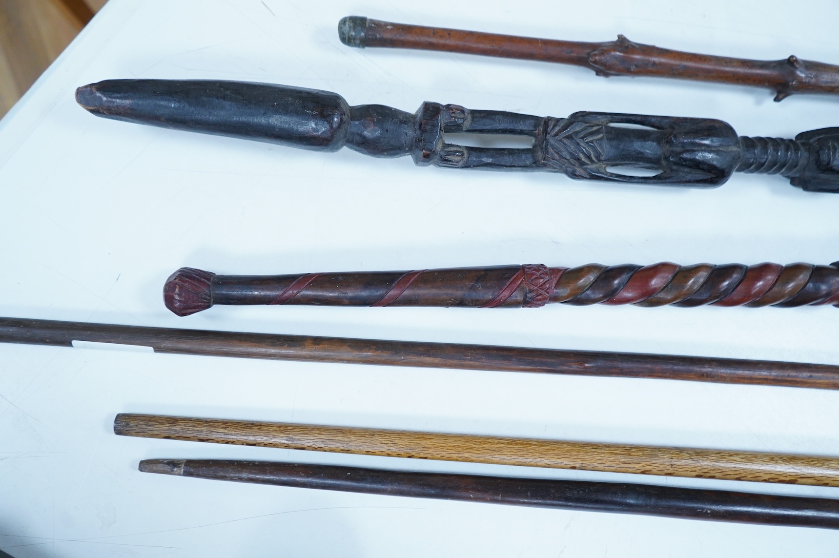 A collection of African and other walking sticks and walking canes - ebonised cane 105 cm long